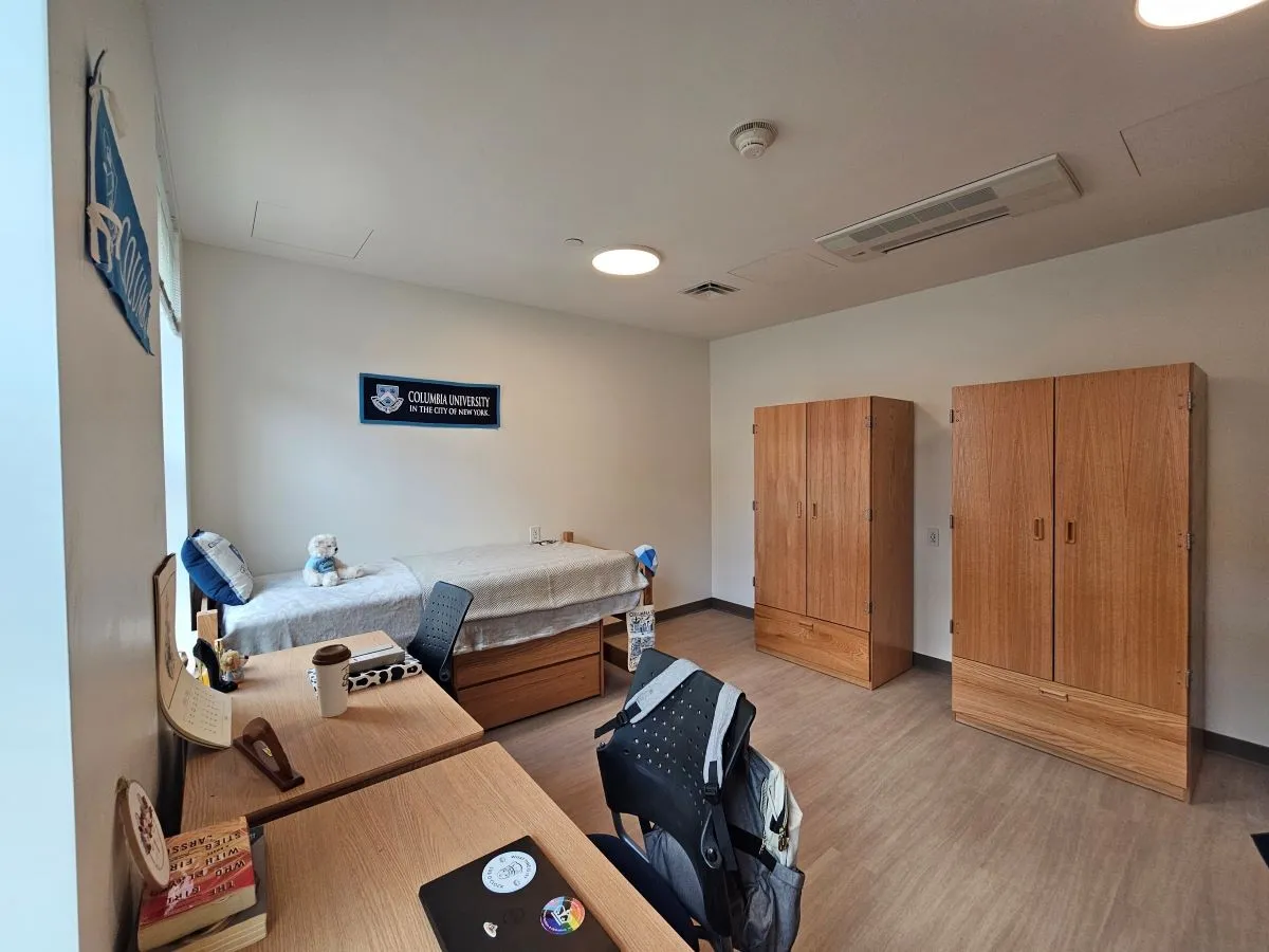 Double room showing one bed, two desks, and two dressers