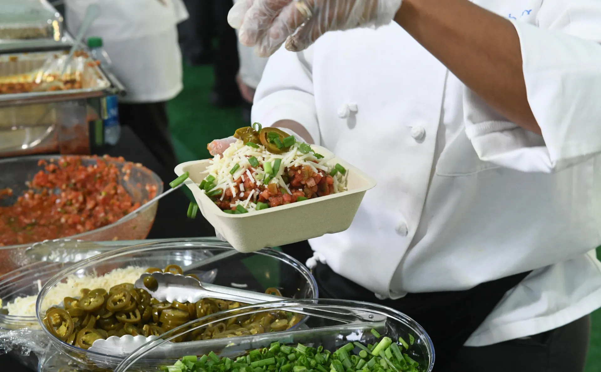Dining employee preparing a bowl
