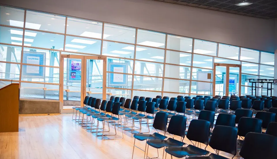 Large meeting space in Lerner Hall with chairs and podium