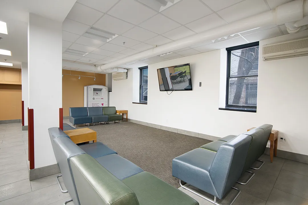 Ruggles building lounge, window view, TV, blue and green seats